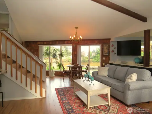 ENTERING THE FRONT DOOR TO THE OPEN CONCEPT LIVING AREA YOU HAVE IMMEDIATE VIEWS OF THE WOOD LOOKFLOORS, VAULTED CEILING AND WATERFRONT!