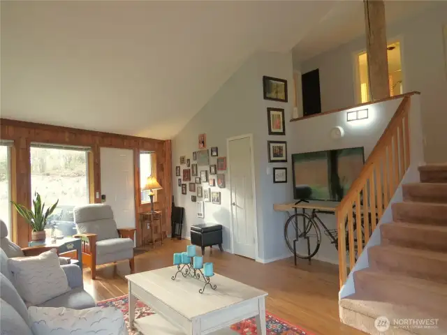 VIEW OF THE LIVING AREA BACK TOWARD THE FRONT DOOR SHOWING THE WOOD-LOOK FLOORS AND VAULTED CEILINGS!