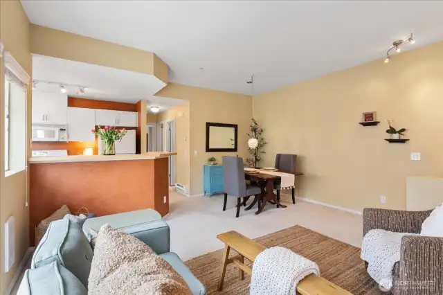 This unit features a kitchen that opens to the living/dining space.