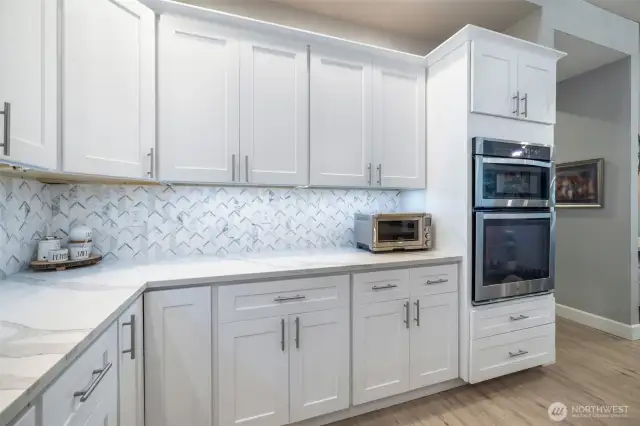 New laser cut marble backsplash and under-cabinet lighting are just a few of the special features in this kitchen.