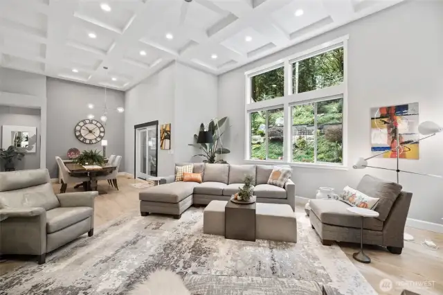 The living room is open to the dining room and kitchen.  Bright lights.  Automated blinds.  Beautiful natural view.  Stunning!
