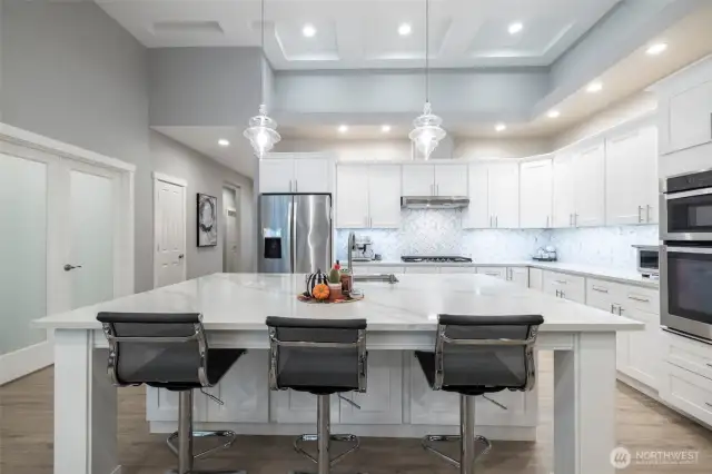 New backsplash, quartz counters, gleaming cabinets.  Stainless appliances.  Kitchen don't get much prettier than this.