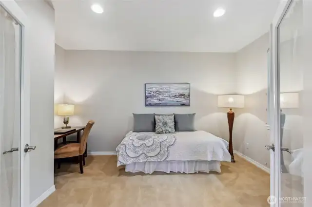 Off the great room is the den/guest room with glass French doors.