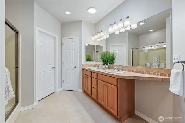 Primary en-suite with dual sinks, step-in shower, walk-in closet and separate water closet.