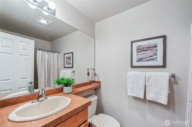 The main bath is just across the hall from the den/guest room.