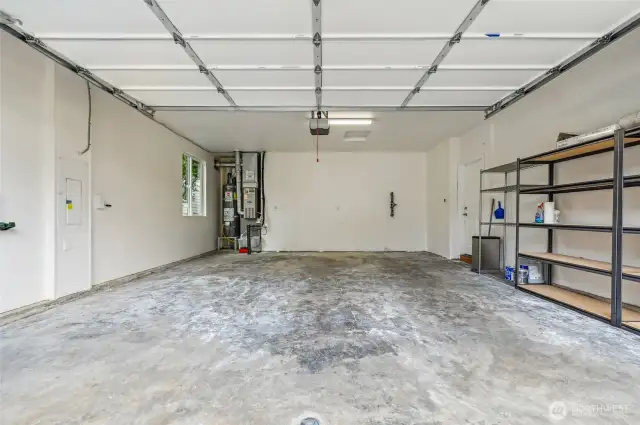 Two car garage with some storage area.