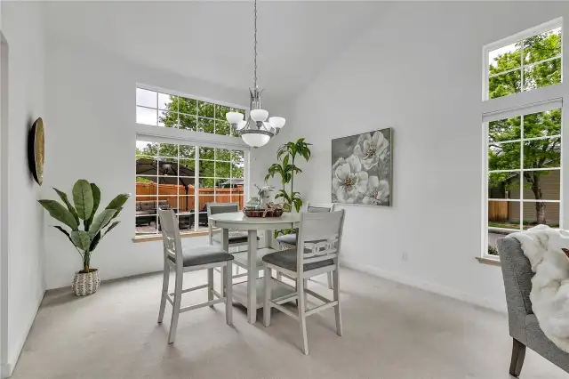 The inviting dining space easily accommodates a large dining set, perfect for family gatherings and celebrations. With a view of the fenced backyard, it offers a warm and welcoming atmosphere for meals and memories.