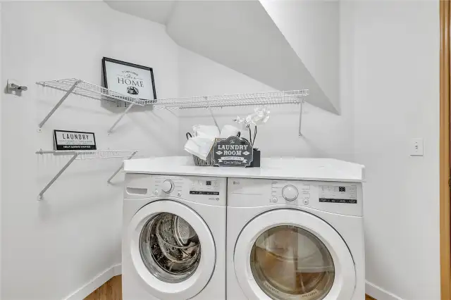 The convenient laundry space just off the garage offers both practicality and ease of access. Featuring a brand-new washer and dryer.