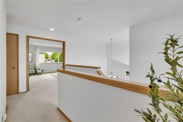 The spacious second-floor landing offers an open, airy feel—no dark hallways here! A grand double-door entry leads into the inviting primary suite. To the left, a convenient linen closet provides easy storage for towels, bedding, and essentials.