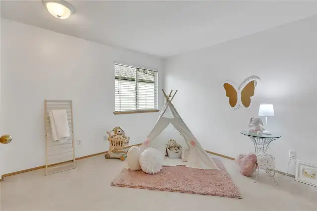 One of three upstairs bedrooms, this comfortable secondary bedroom offers versatility and charm, perfect for guests, family, or a personalized retreat.