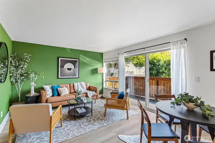 Light filled living room with glass slider to private patio