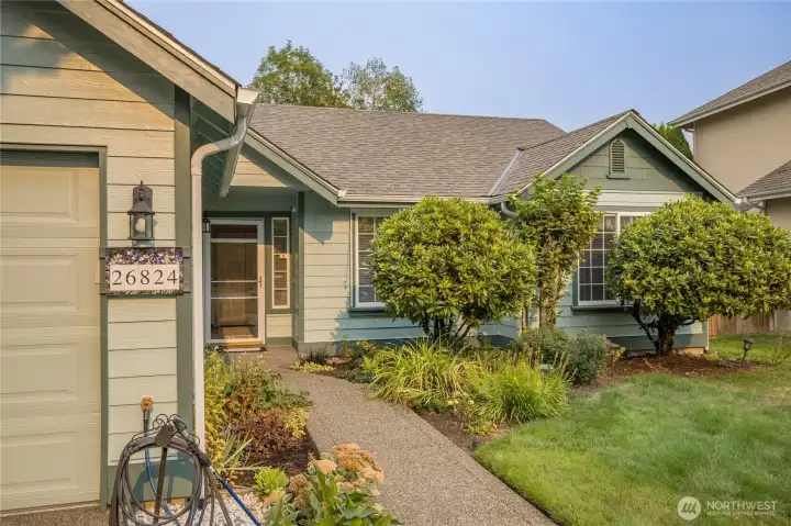 Well-maintained mature landscaping with front and rear sprinkler system