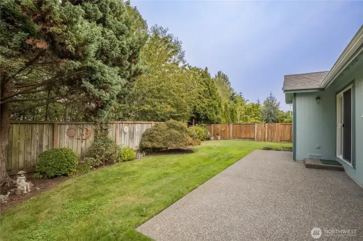 Level yard has mature trees behind for excellent privacy
