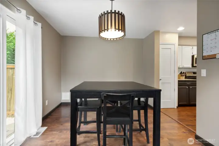 The dining room is nice sized and to the left a slider leads to the fully fenced backyard and swing!