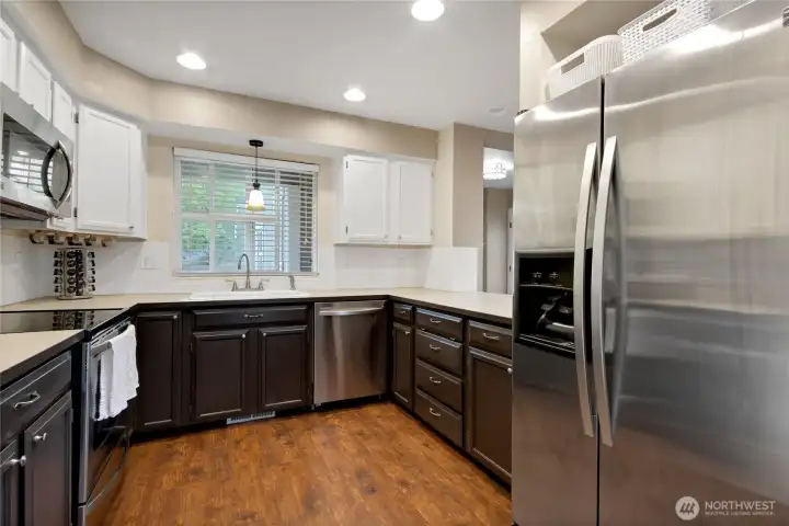 What a beautiful kitchen! Canned lighting, stainless steel appliance, deep kitchen sink.