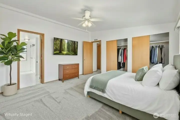 Look towards the bath & doorway in the primary bedroom. Virtually staged