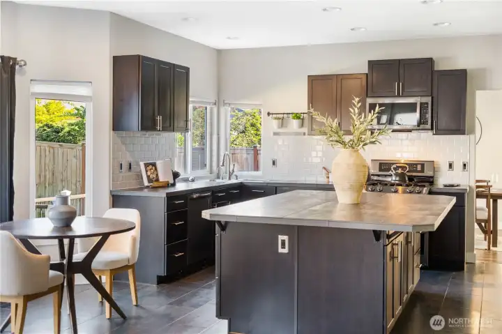 Light & Bright kitchen with eating nook. Slider opens to the backyard to the left. To the right move toward the front entry or the main level office. Behind is the Family Room