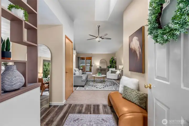 Just through the front door you'll see into the vaulted entry, with display shelving, engineered hardwood floors & a sizable entry closet. The living room is to the left and the family room is straight ahead with screened in sunroom and deck beyond.