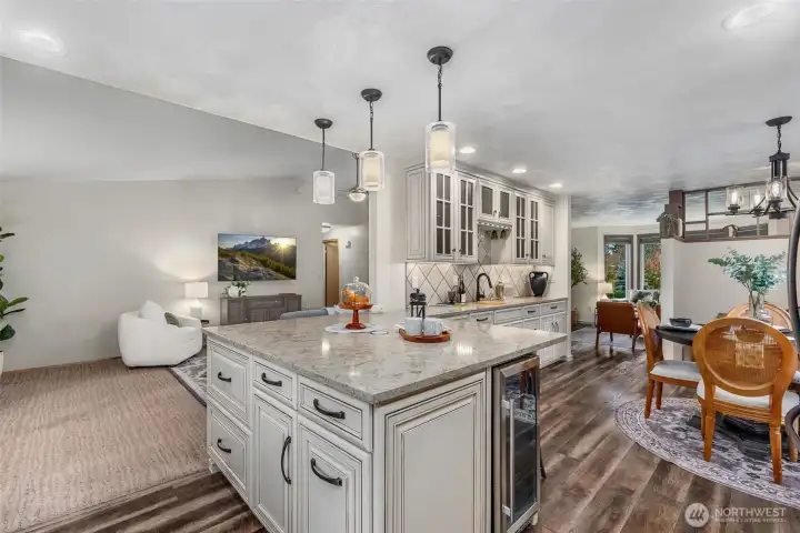 Look closely to find a pop-up charging station with outlets in the center of the quartz peninsula! Love the storage options and beautiful detail in this space!