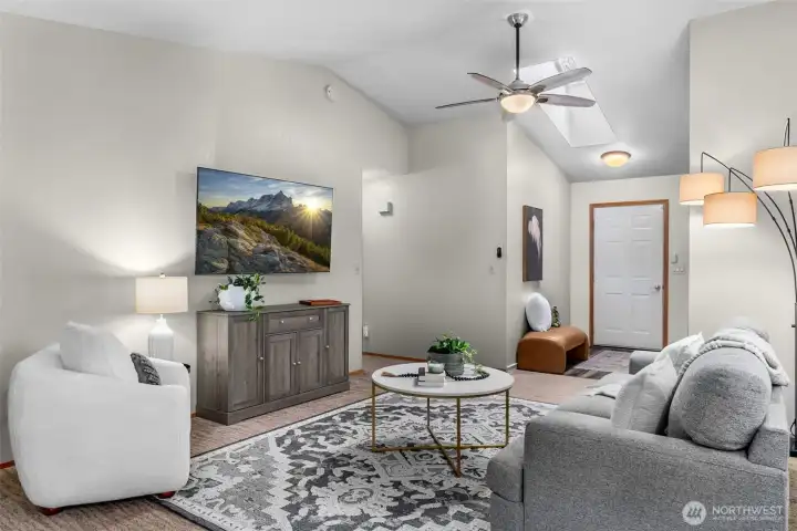 Family room boasts vaulted ceiling with skylight & ceiling fan/light fixture.