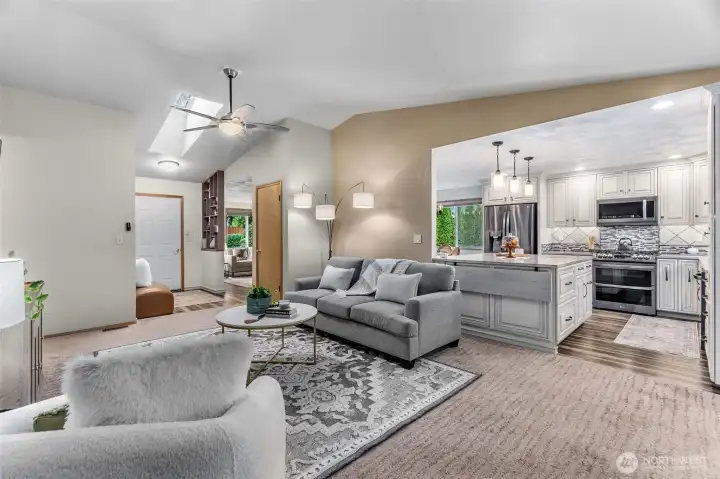 This angle shows easy flow from the family room to kitchen, dining, living & entry. A hallway on the left leads to bedrooms & bathrooms.