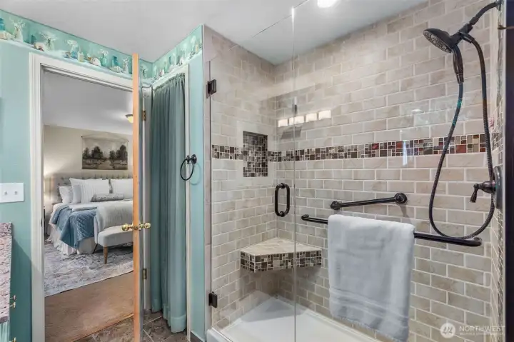 Love the fablulous full tile walk-in shower with floor to ceiling tile & gleaming glass doors! A storage closet to the left of the shower offers space for towels, toiletries & supplies.