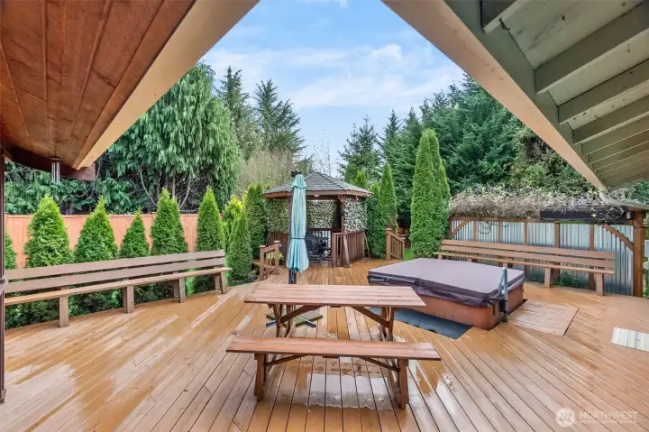 Enjoy serene, private outdoor living with sprawling deck, hot tub, gazebo for dining & generous seating for everyone!