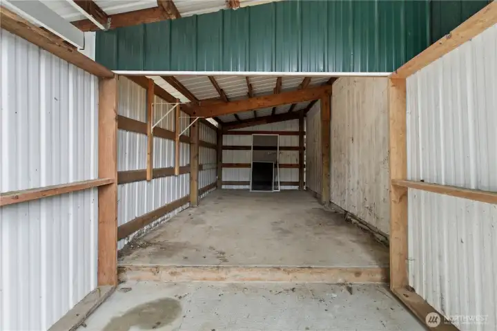 Dry covered wood shed attached to the garage.