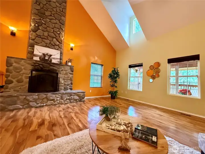 Back in the great room, the river-rock wood fireplace is dramatically beautiful!