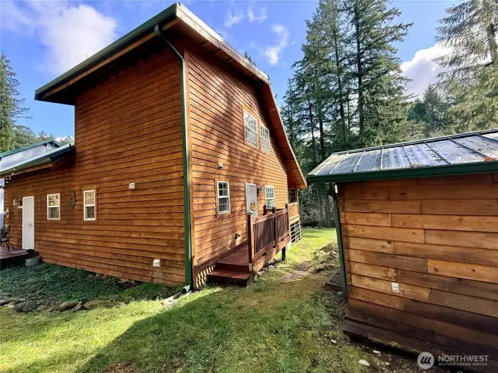 Front-side of the home, with an outbuilding uses for storage.