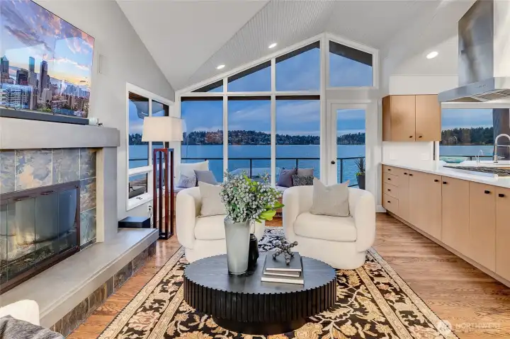 The adjoining family room is anchored by a cozy fireplace, while slab quartz countertops and designer lighting add a refined touch.