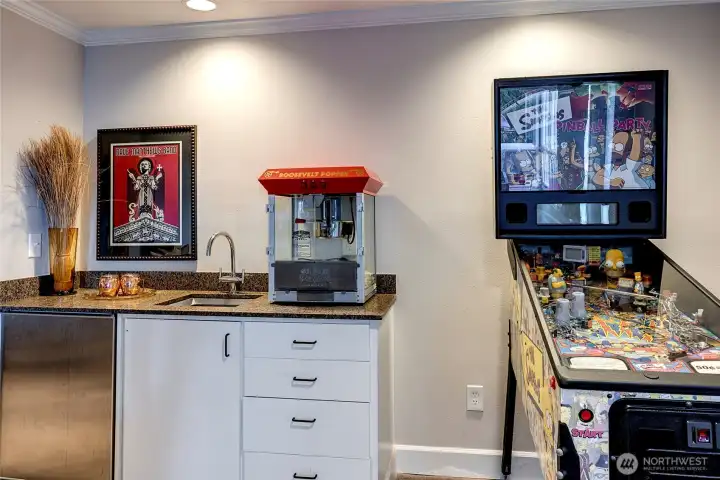 wet bar with a mini fridge keeps snacks and drinks within easy reach.