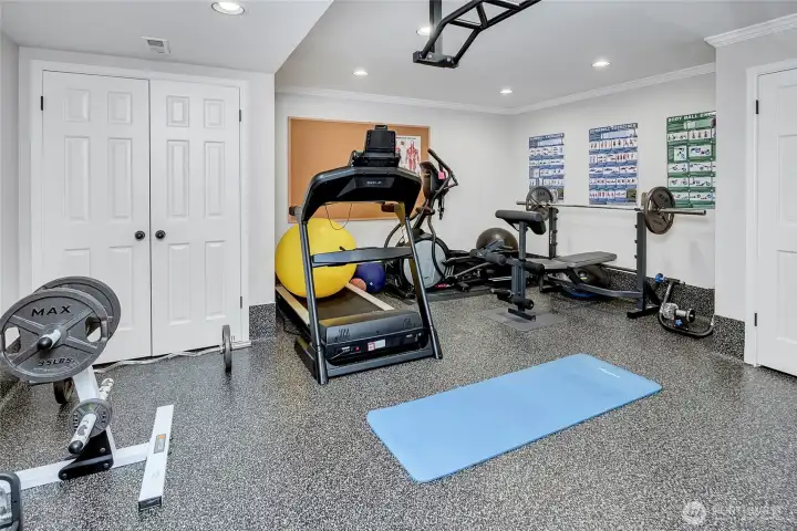 Skip the gym membership, this dedicated workout space is fully equipped for weights, a treadmill for convenient everyday training.