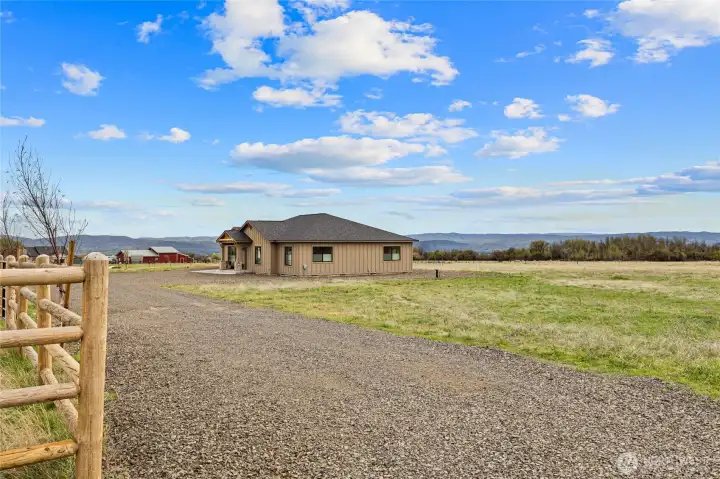 Gravel driveway- 9 birch trees with drip system along the fence