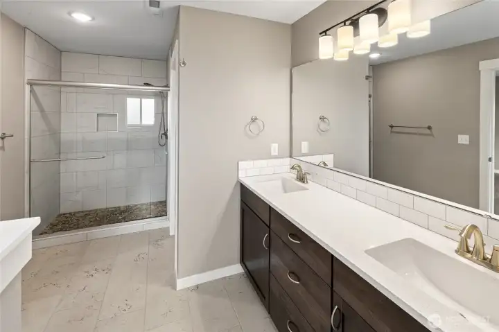 Primary Bathroom 3/4 tile and stone in shower. Separate tub and storage closet