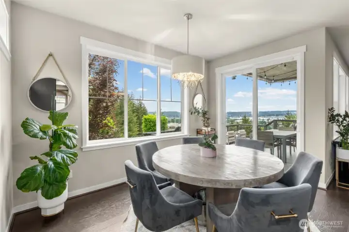 The dining room earns its own moment — corner windows and a slider to the upper deck frame sweeping views of the valley and surrounding hills, making every meal feel like more than just a meal