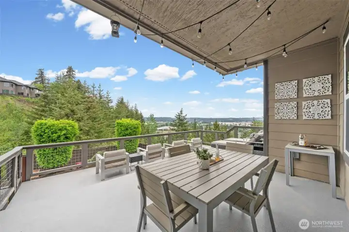 Accessed directly from the kitchen eating space, this expansive upper deck features covering from the elements,  and a gas hookup for BBQ — all framed by sweeping panoramic valley views.