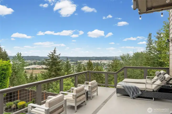 Unobstructed valley views stretch for miles from this upper deck — a rare West Hill vantage point that turns everyday moments into something worth pausing for.