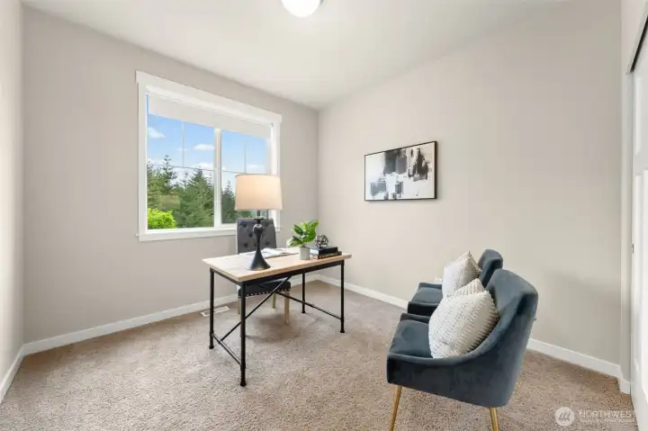 A versatile main level bedroom with treetop views and closet — equally suited as a private home office, guest room, or flex space for whatever life requires.