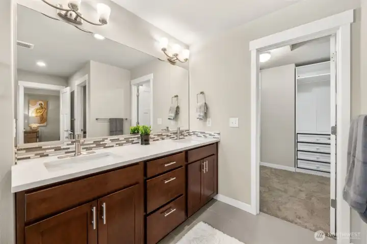 The dual vanity continues to the second angle, revealing direct access to the walk-in closet — a seamless morning routine from bath to wardrobe without a single wasted step.