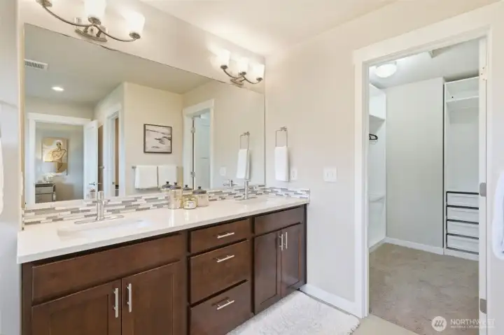 The dual vanity continues to the second angle, revealing direct access to the walk-in closet — a seamless morning routine from bath to wardrobe without a single wasted step.