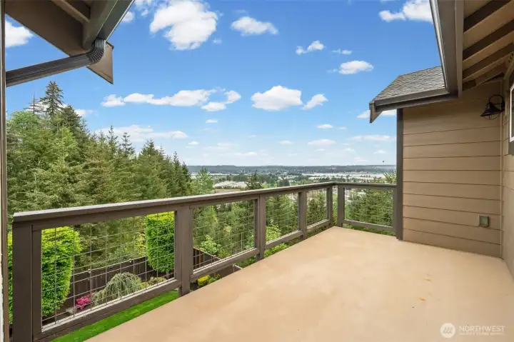 Step directly from the primary suite onto your own private deck — an unobstructed West Hill vantage point with sweeping valley views that make waking up here feel like an entirely different kind of morning