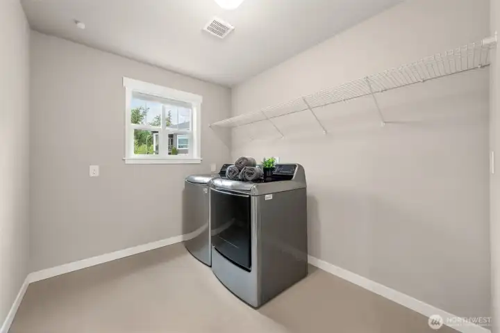 Conveniently located on the same level as the bedrooms, this dedicated laundry room features full-size washer and dryer, built-in shelving, and a window — no more hauling laundry up and down stairs.