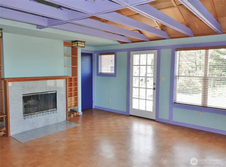 Living Area and Entry w/ a wood-burning fireplace.