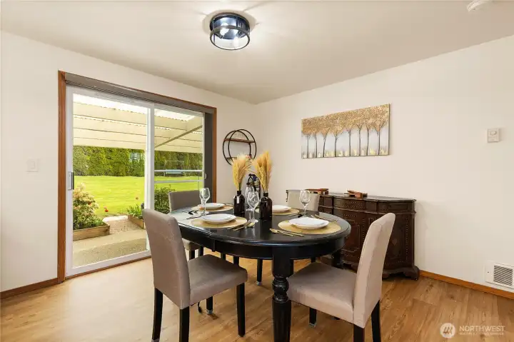 Formal dining room adjoining an expansive sliding glass door that opens to a covered patio.