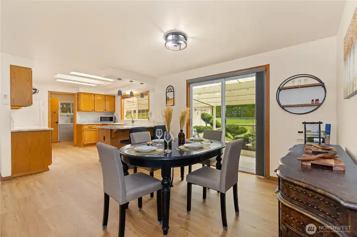 Formal dining room adjoining an expansive sliding glass door that opens to a covered patio.