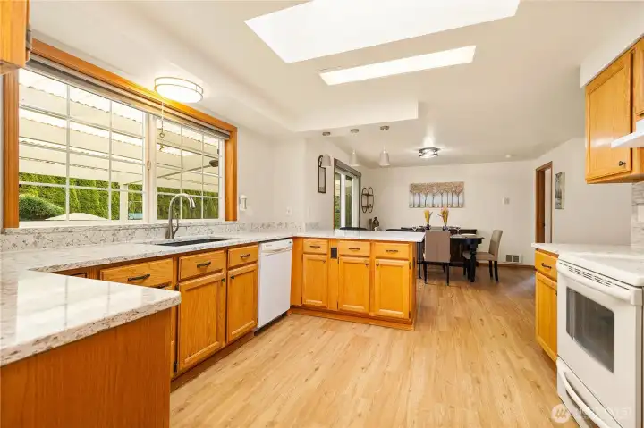 A spacious kitchen with a large, beautiful window that fills the space with natural light.