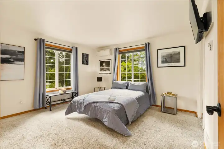 Primary bedroom with ensuite bath featuring a shower, tub, and a large countertop with a makeup station.