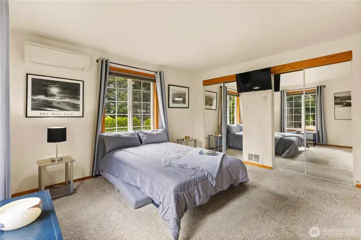 Primary bedroom with ensuite bath featuring a shower, tub, and a large countertop with a makeup station.