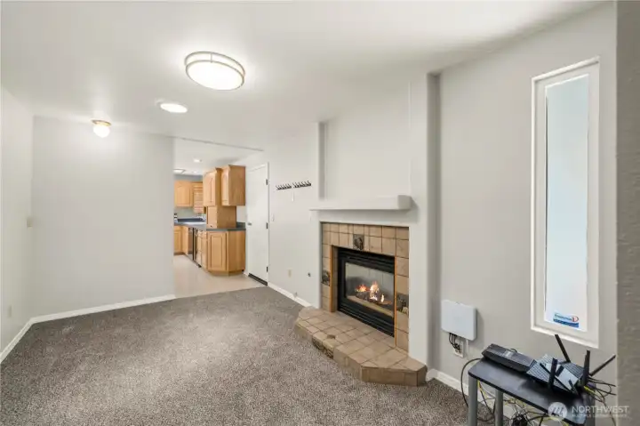 The formal living room has easy access to the kitchen plus a cozy fireplace. The formal living room has easy access to the kitchen plus a cozy fireplace.